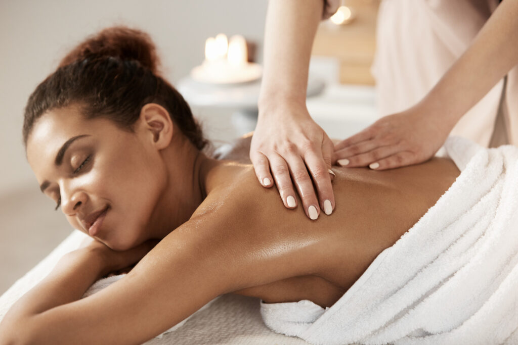 attractive-african-woman-having-massage-relaxing-spa-salon-closed-eyes