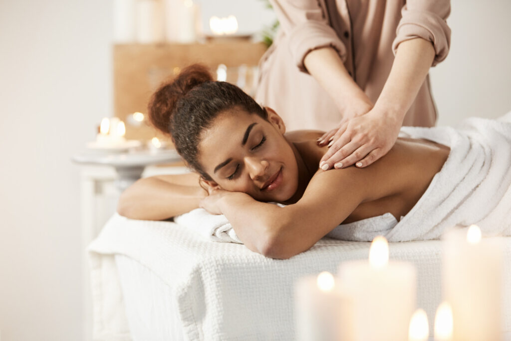 beautiful-african-woman-smiling-enjoying-massage-with-closed-eyes-spa-salon